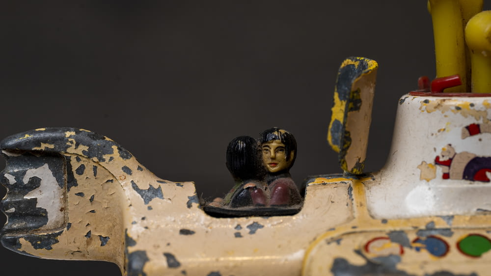 a close up of a toy train with a figurine on top of it