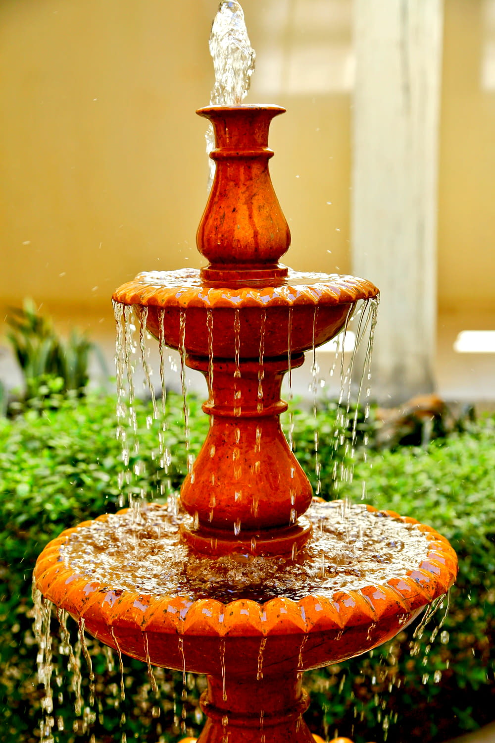 a red fountain with water running down it