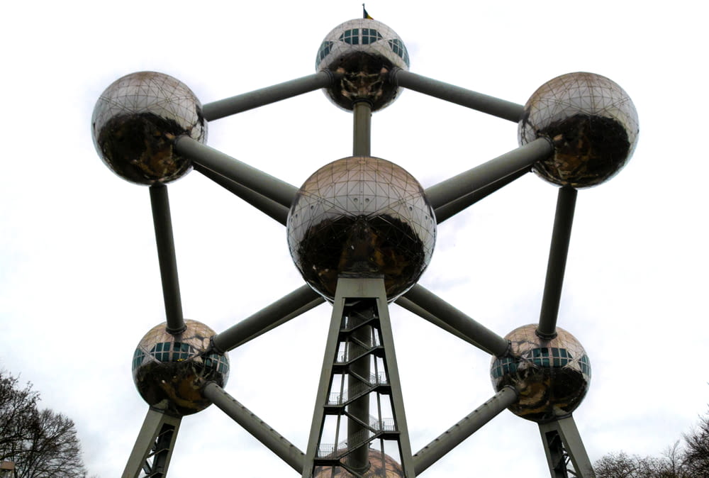 a large metal structure with mirrored balls on it