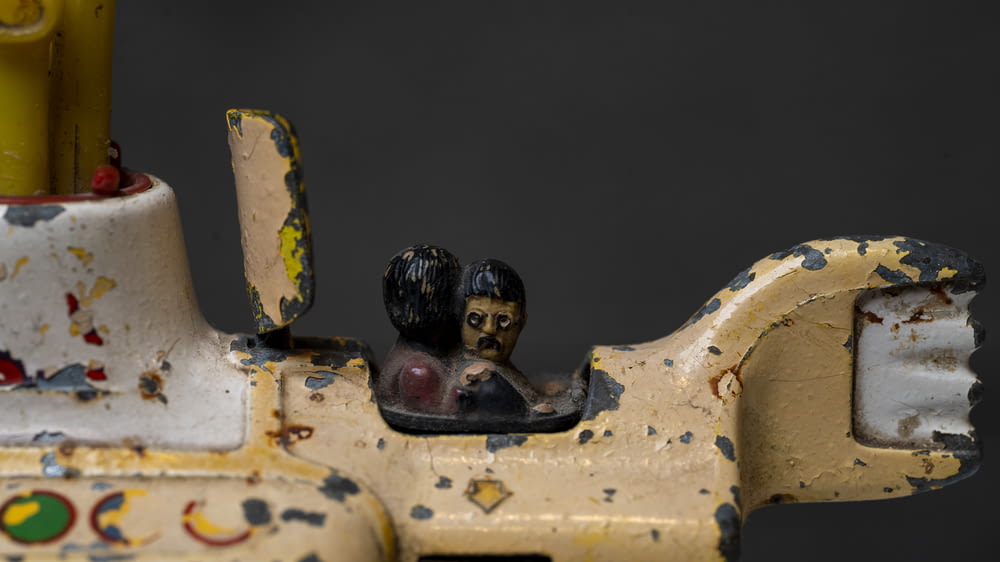 a close up of a toy car with a figurine on top of it