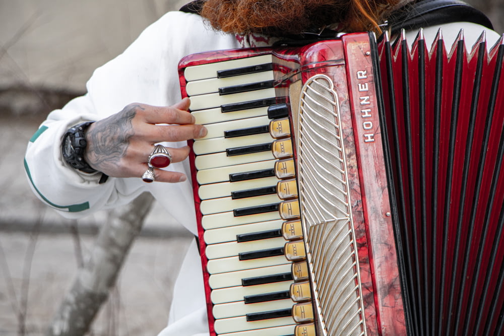 a close up of a person playing an accordion