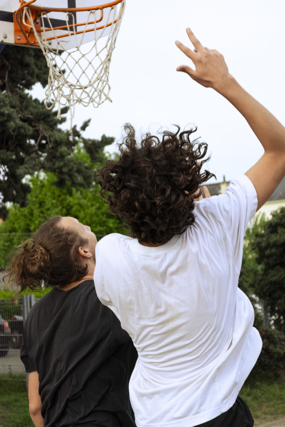 a couple of people playing a game of basketball
