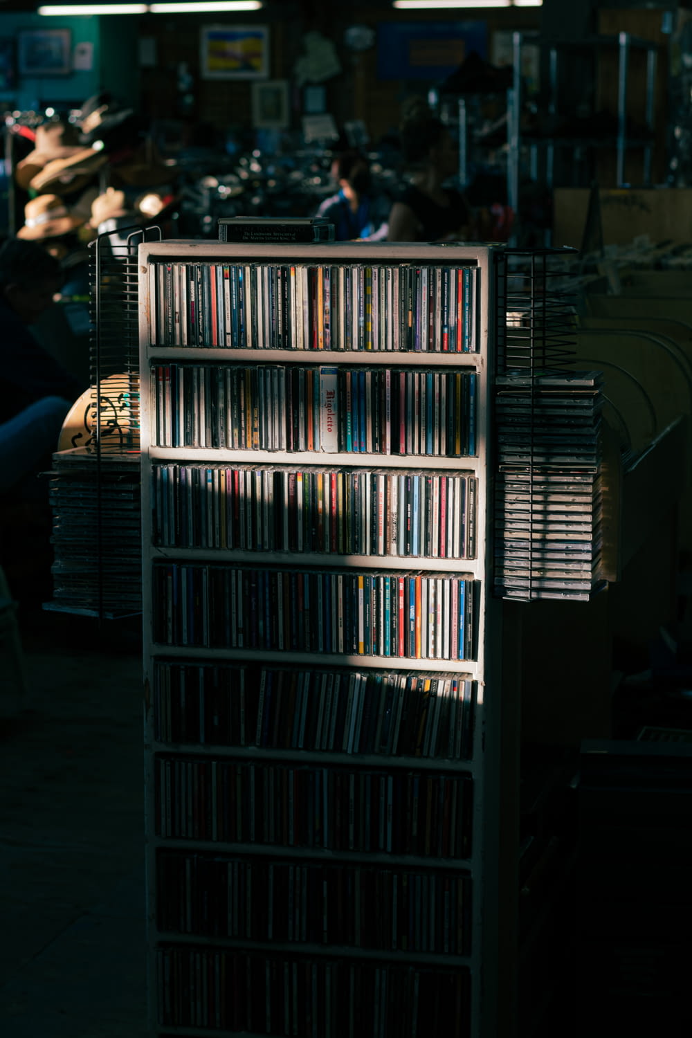 a rack of cd's sitting on a sidewalk