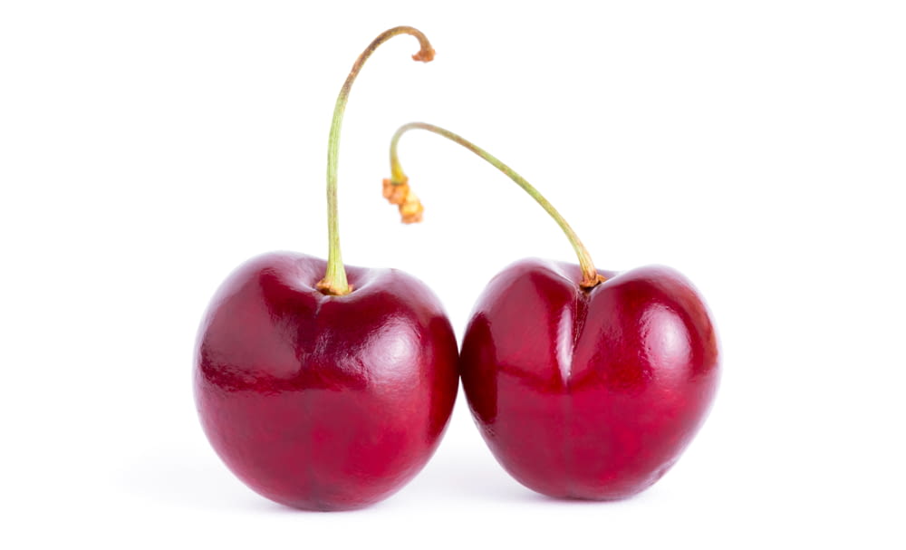 two cherries are shown on a white background