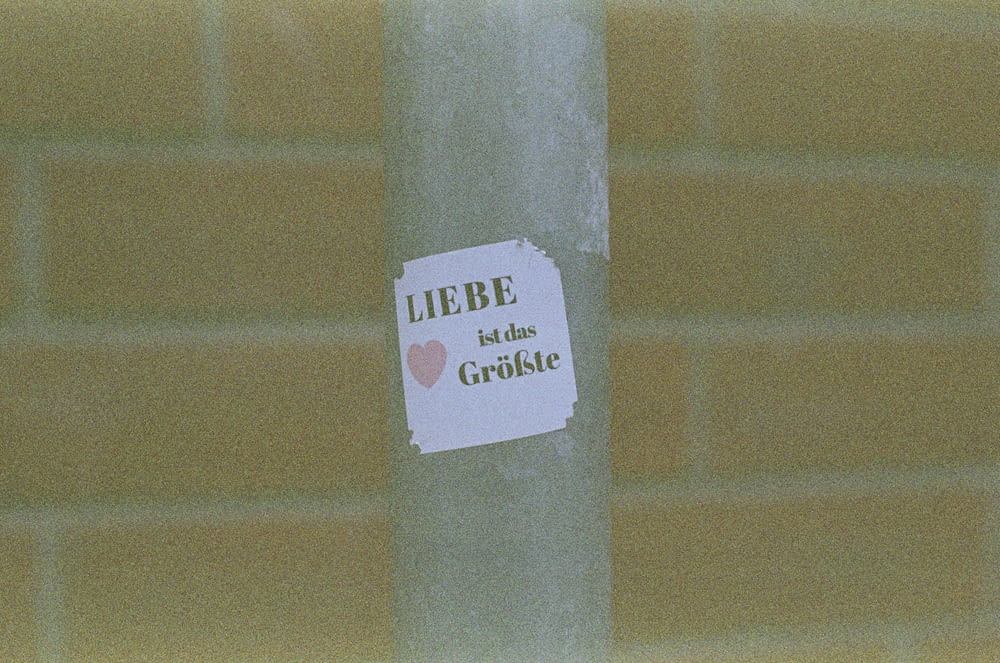 a sticker on a pole with a message on it