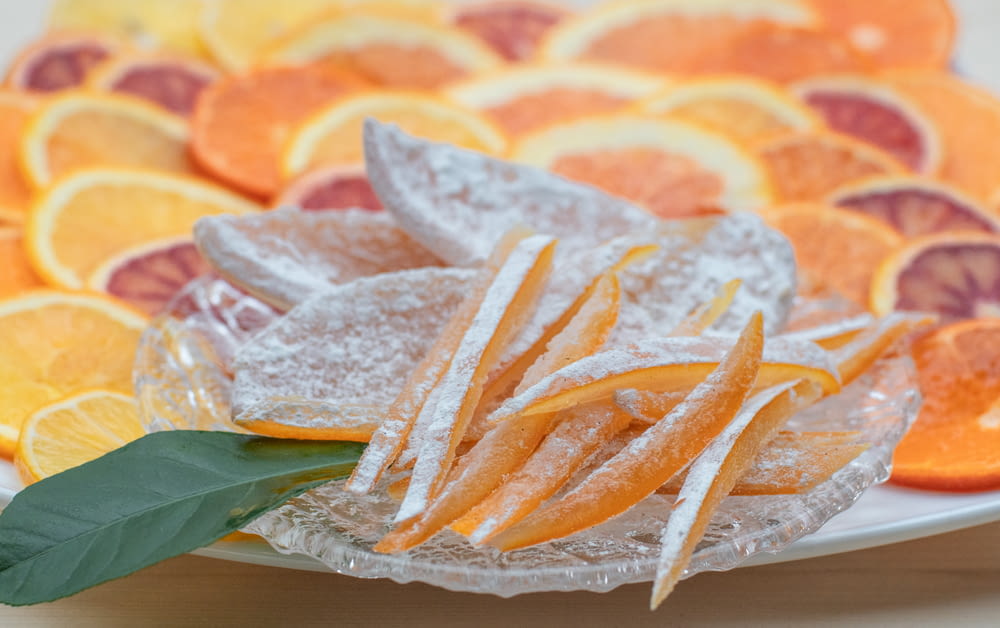 a white plate topped with orange slices covered in sugar