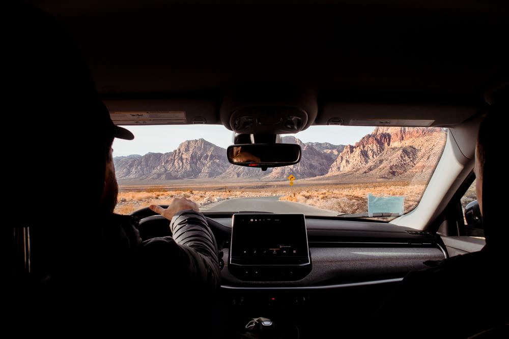 a person driving a car in the desert