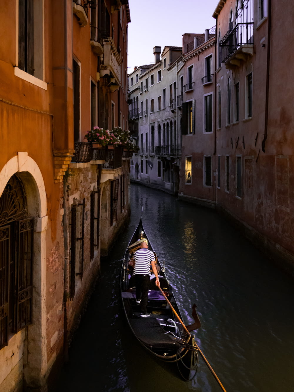 a gondola in a narrow canal between two buildings