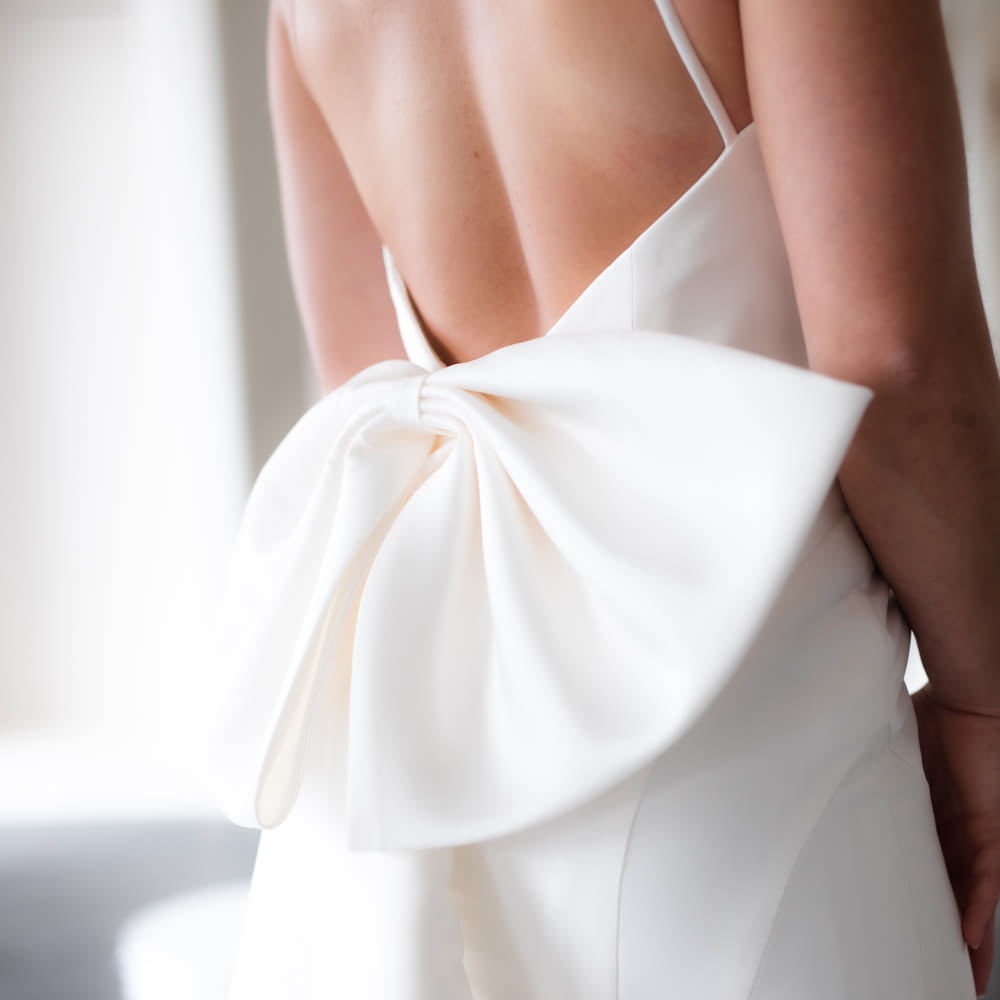 the back of a woman's dress with a large bow