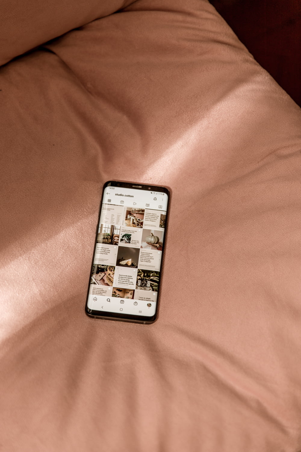 a cell phone sitting on top of a bed
