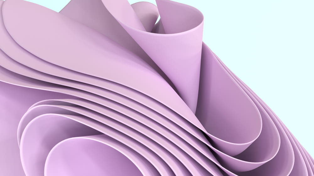 a close up of a stack of purple paper