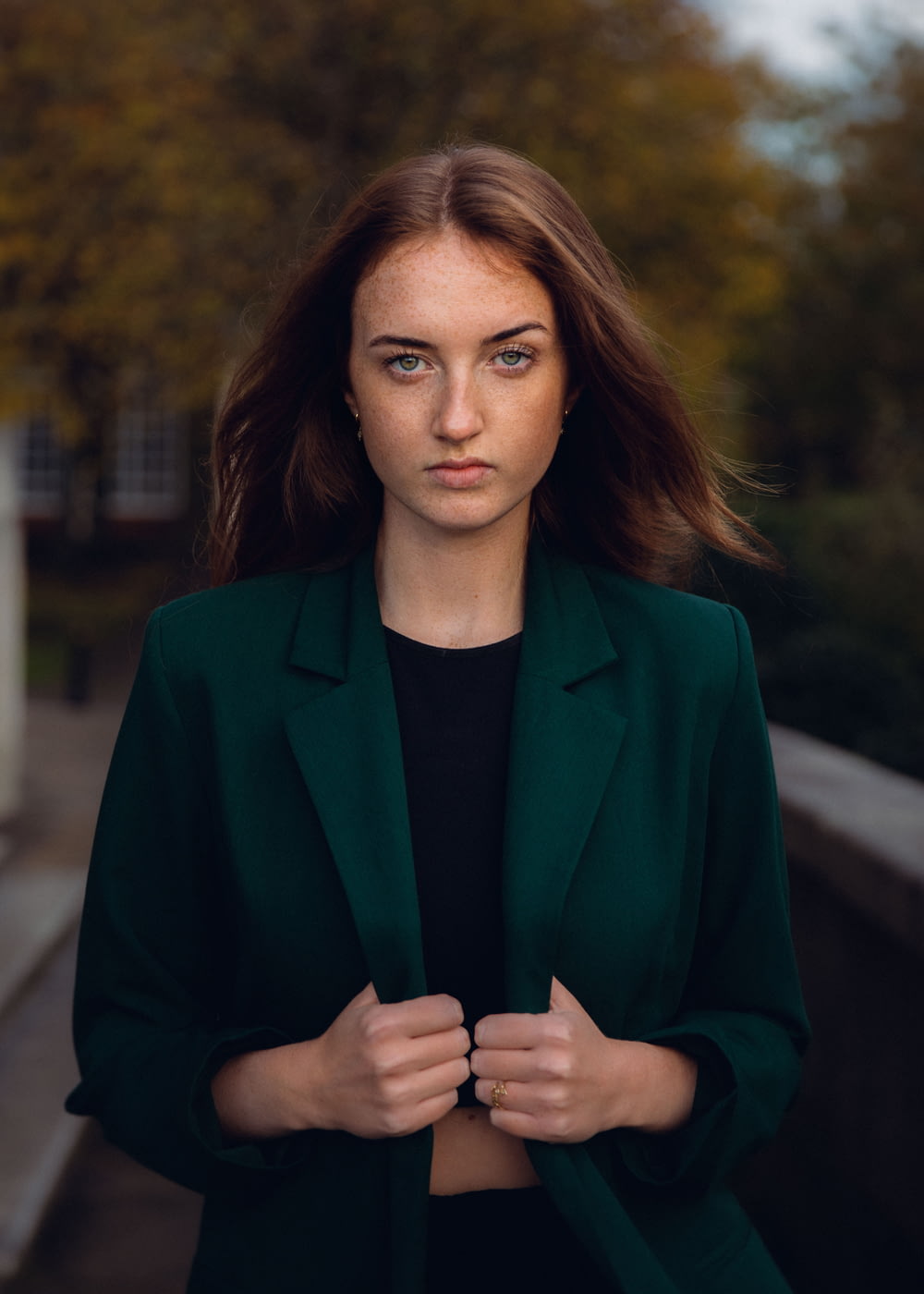 a woman in a green jacket and black shirt