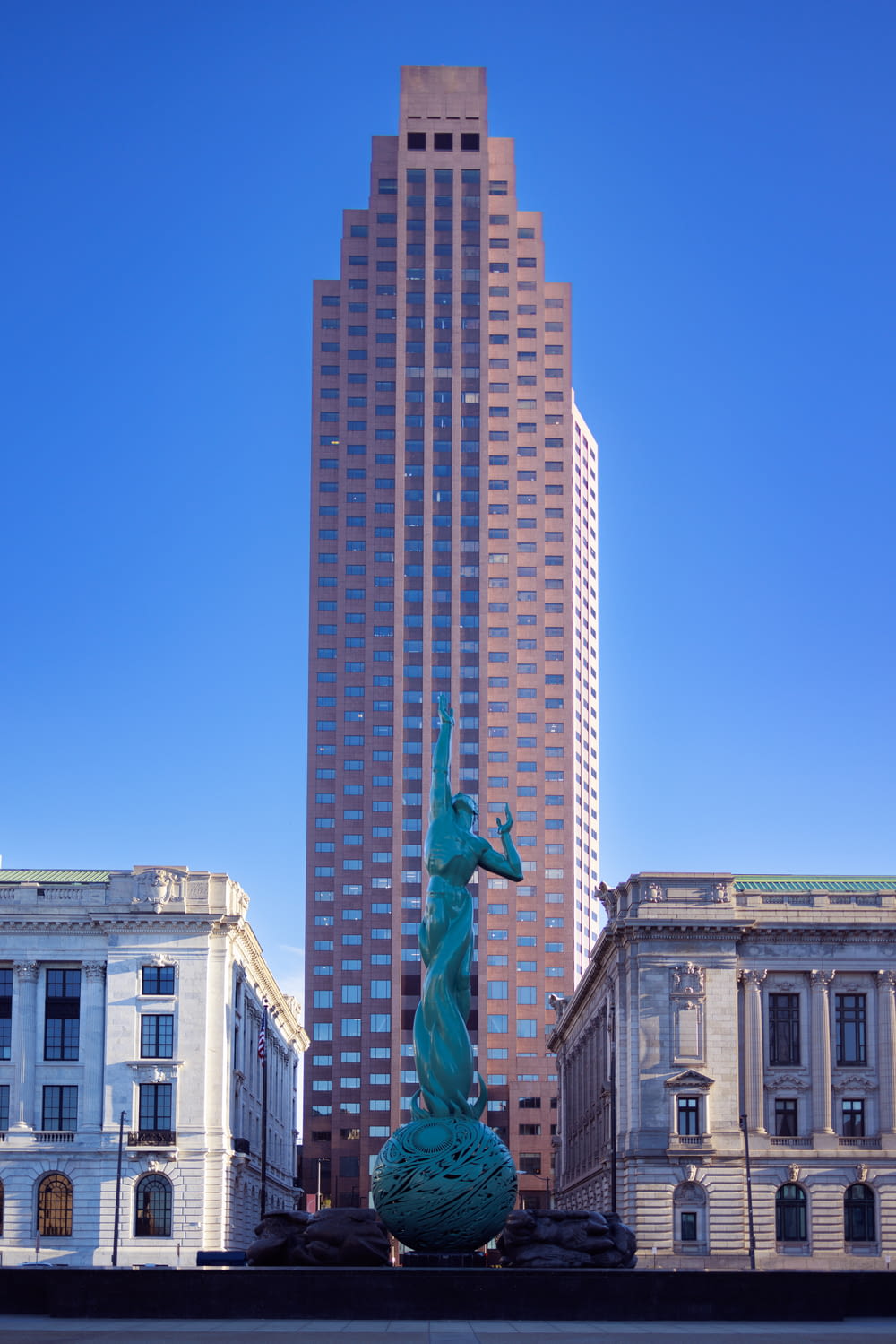 a statue of a horse in front of a tall building