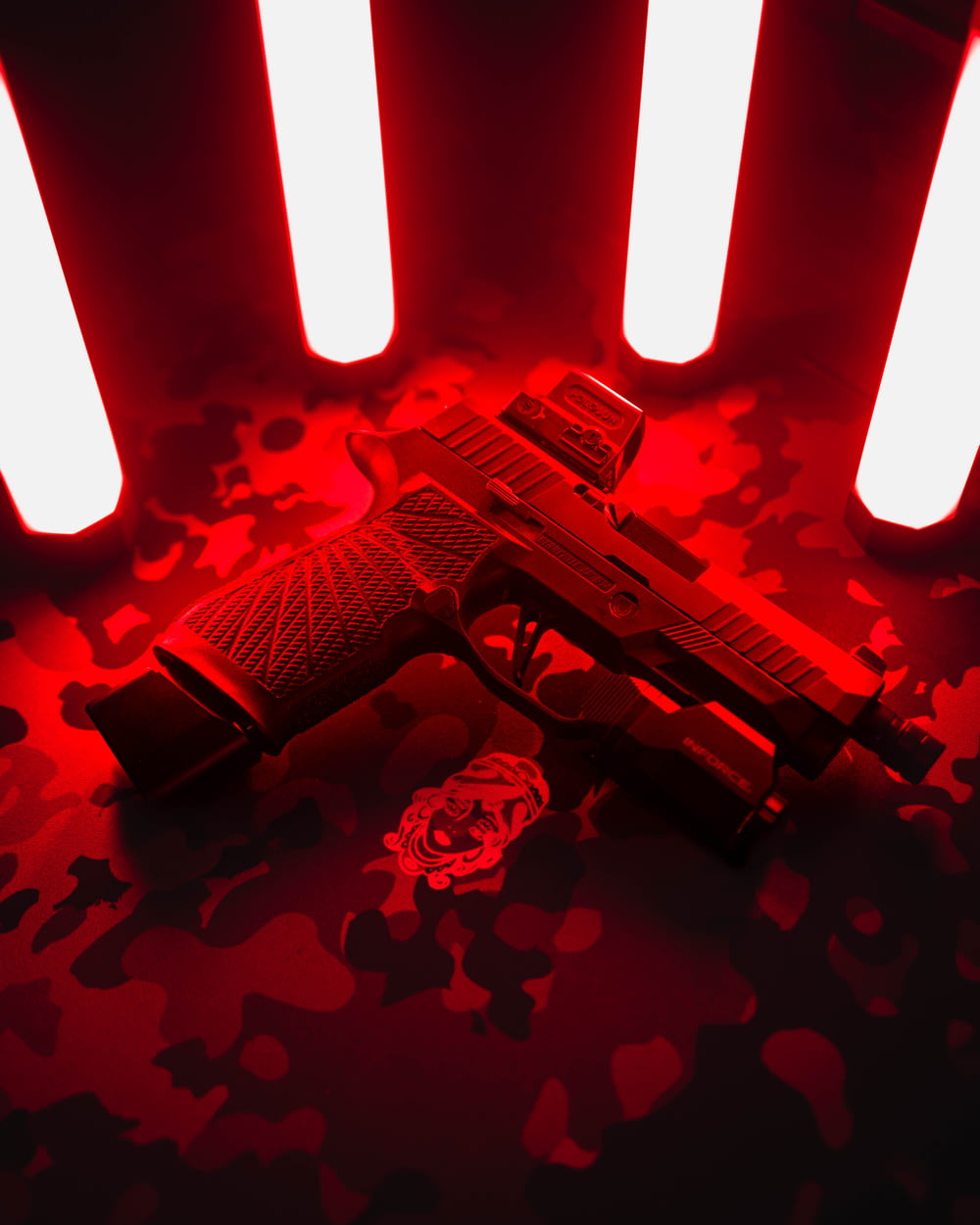 a red light gun laying on a black background