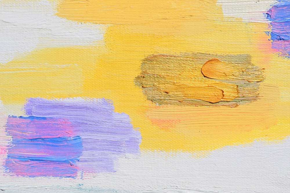 a close up of a painting with yellow and purple colors