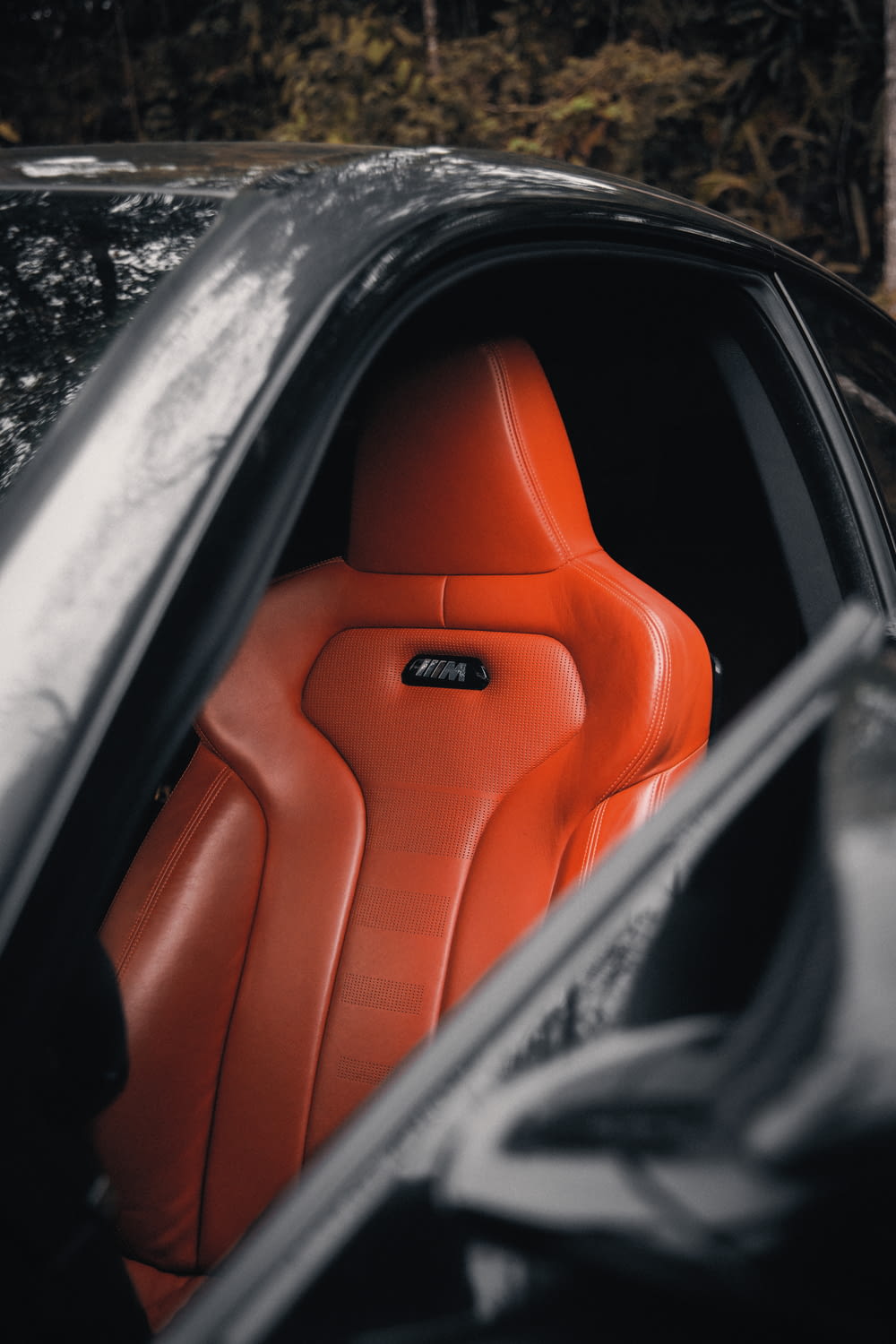 the interior of a car with a red seat