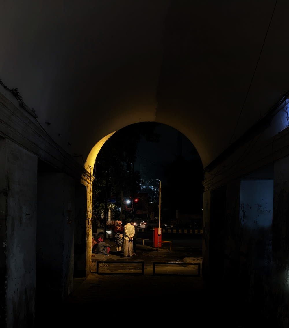 a dark tunnel with a man standing in it