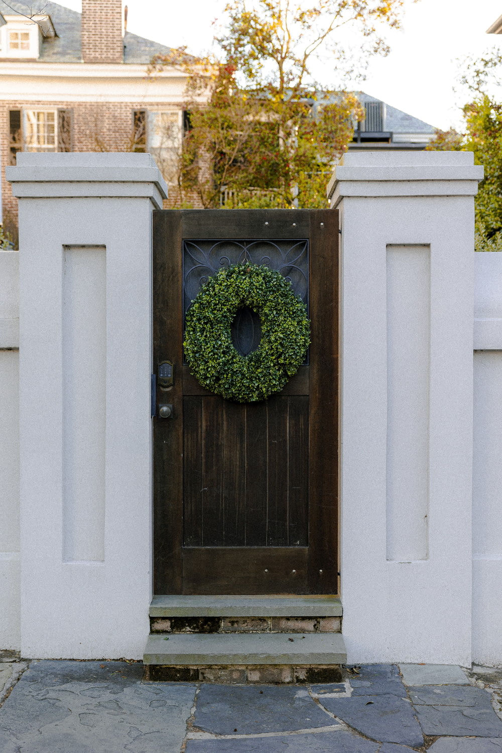 a wooden door with a wreath on it