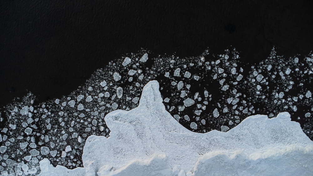 an aerial view of snow and ice on the water