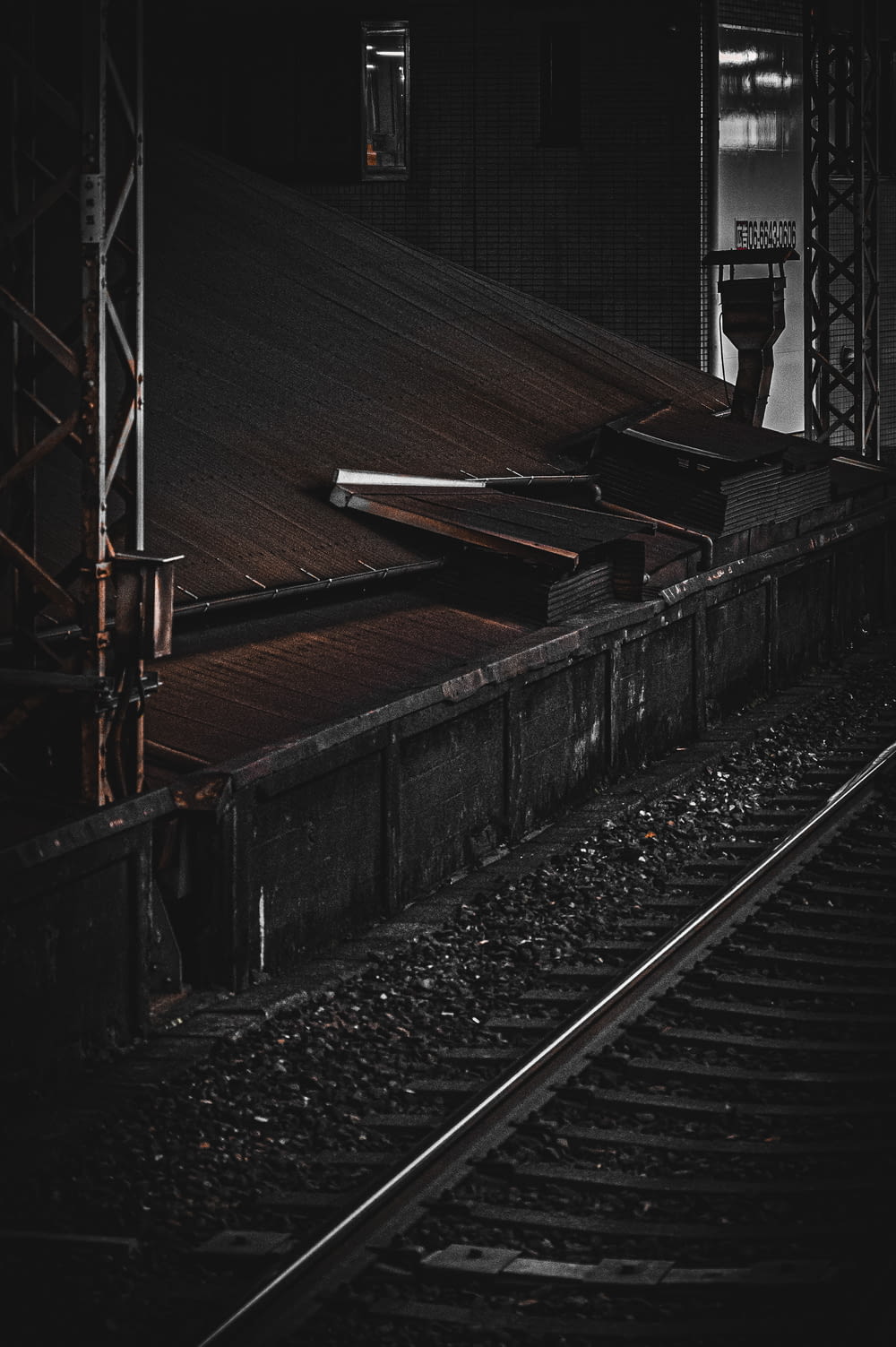 a person standing on a train track in the dark