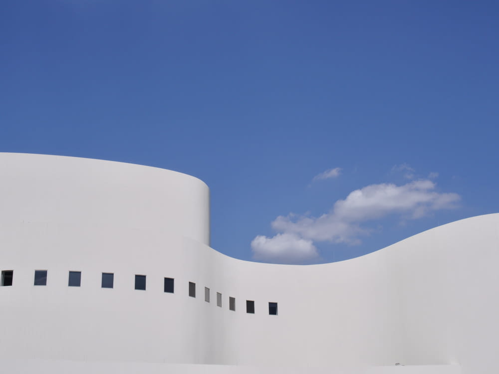 a white building with a blue sky in the background