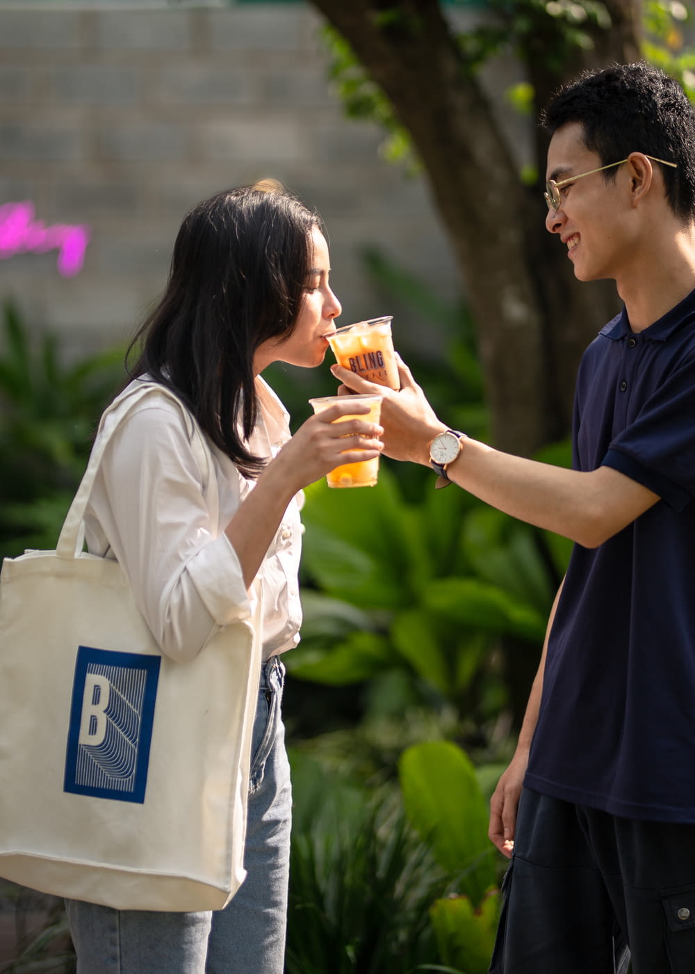 a man and a woman sharing a drink together