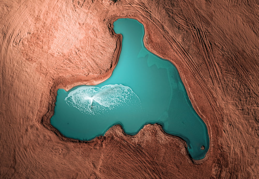 an aerial view of a lake in the desert