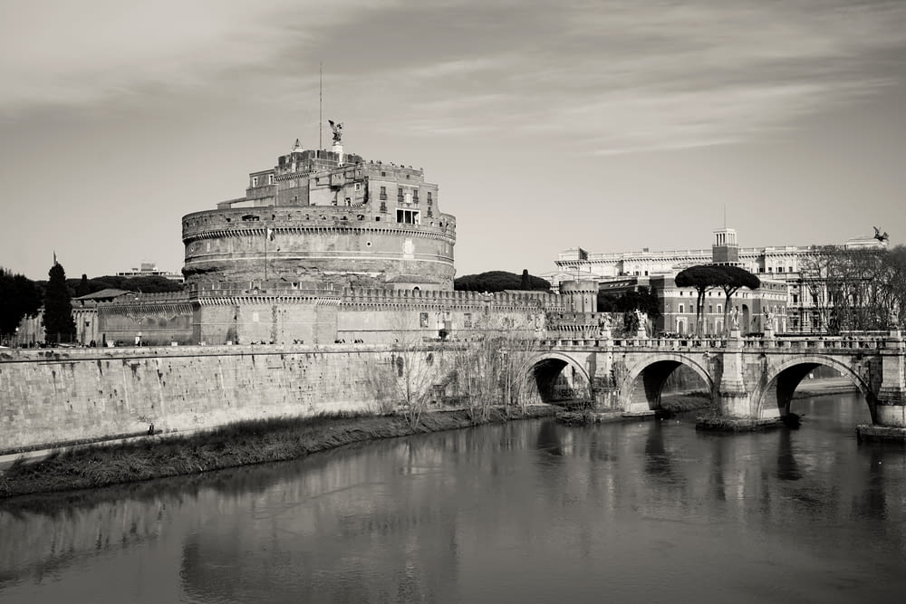 a black and white photo of a bridge and a castle
