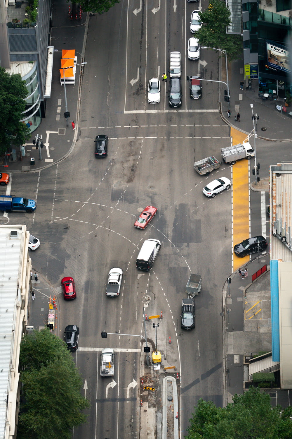 an aerial view of a city intersection with cars and trucks