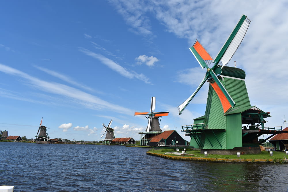 a group of windmills sitting next to a body of water