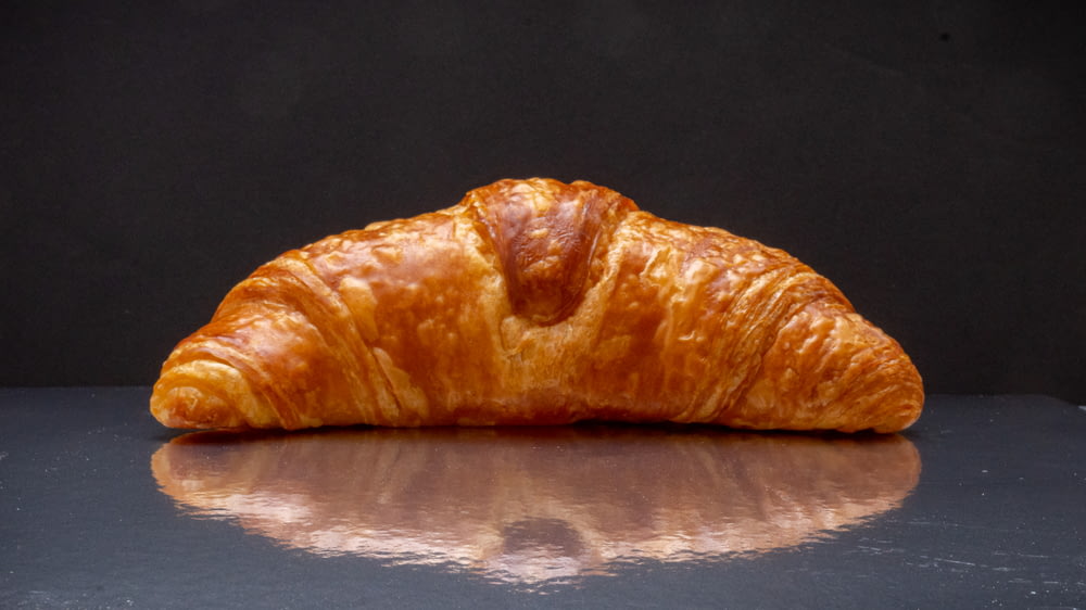 a close up of a croissant on a table