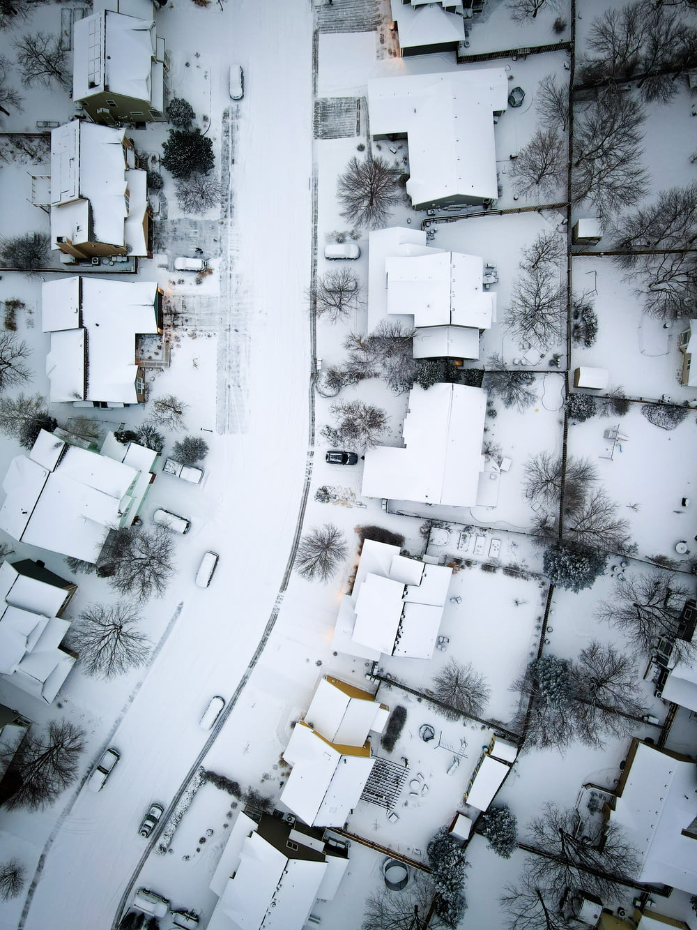 an aerial view of a neighborhood covered in snow