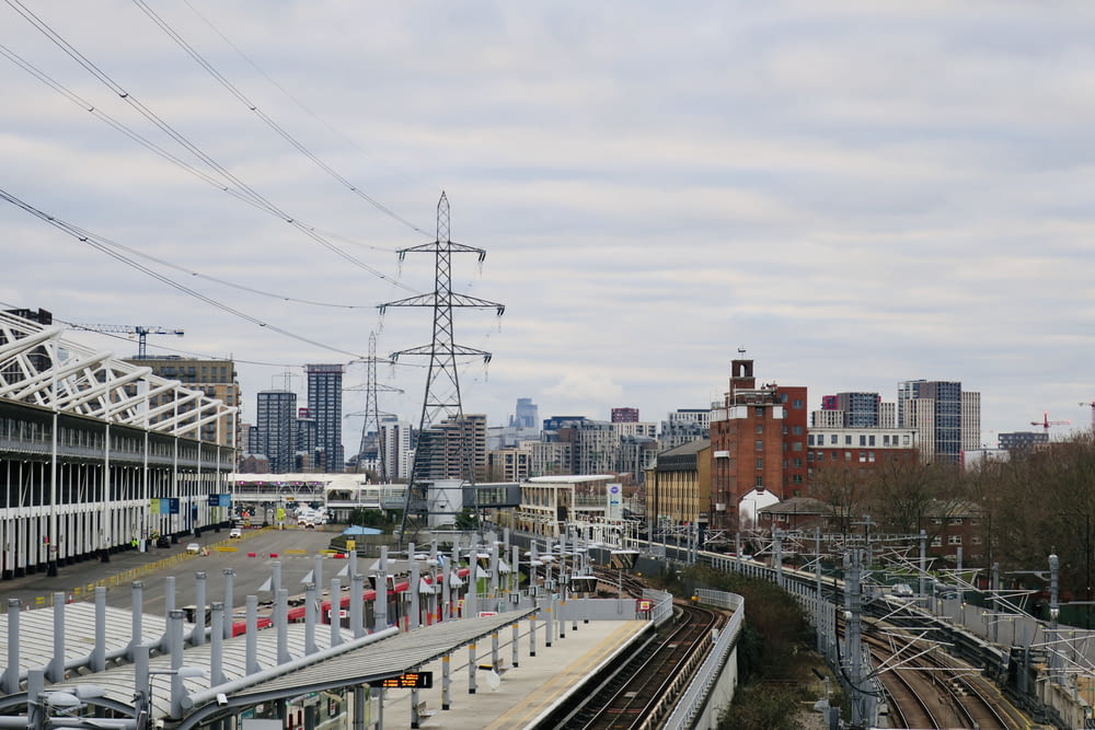 a view of a train station with a city in the background