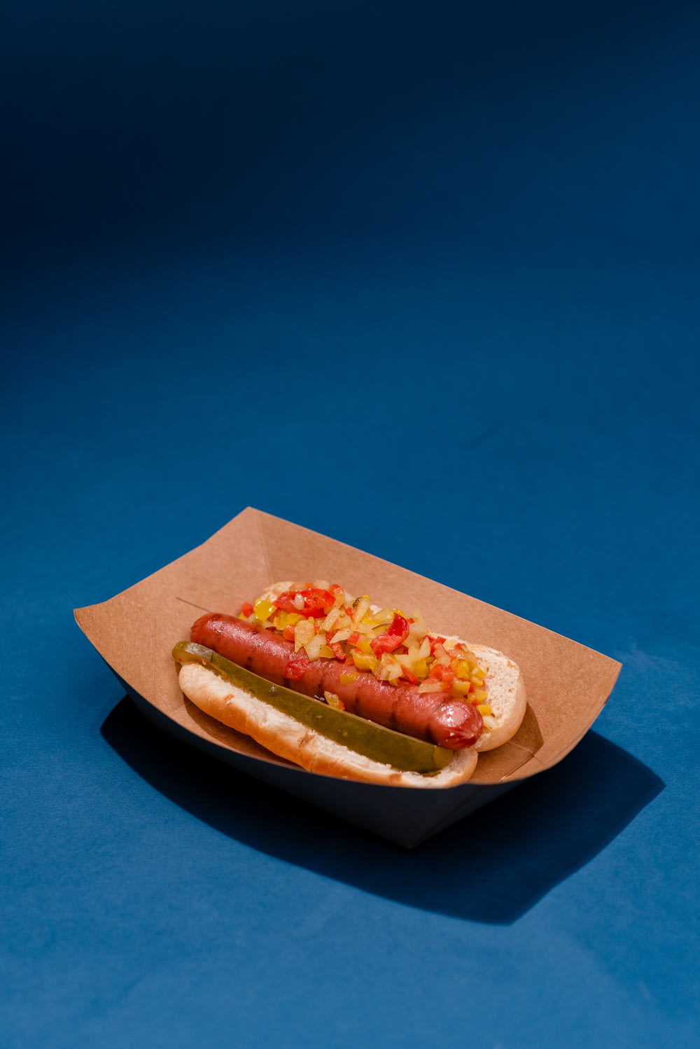 a hot dog with relish and mustard on a bun