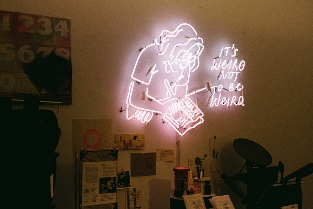 a neon sign on the wall of a room