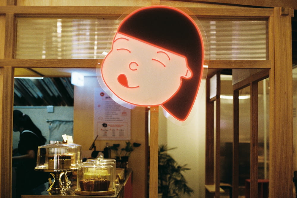 a neon sign with a woman's face on it