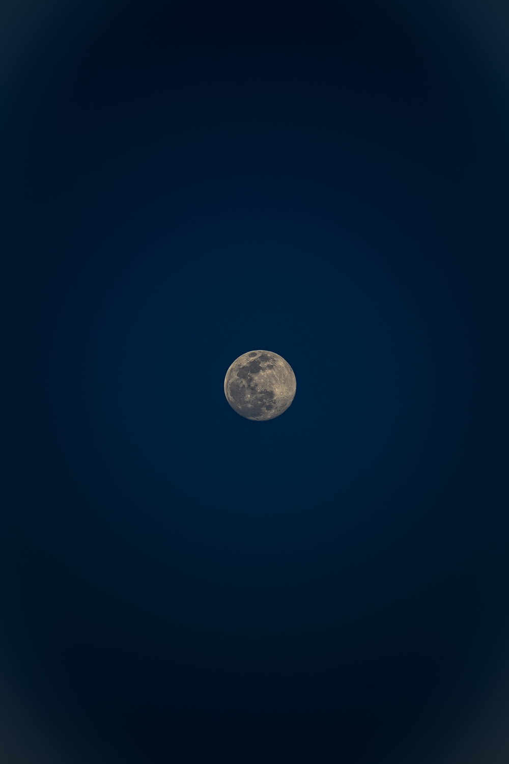 a full moon is seen in the night sky