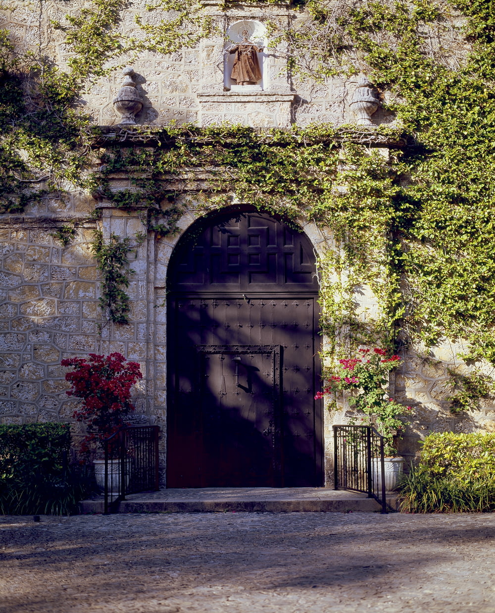 a building with a black door and a black gate