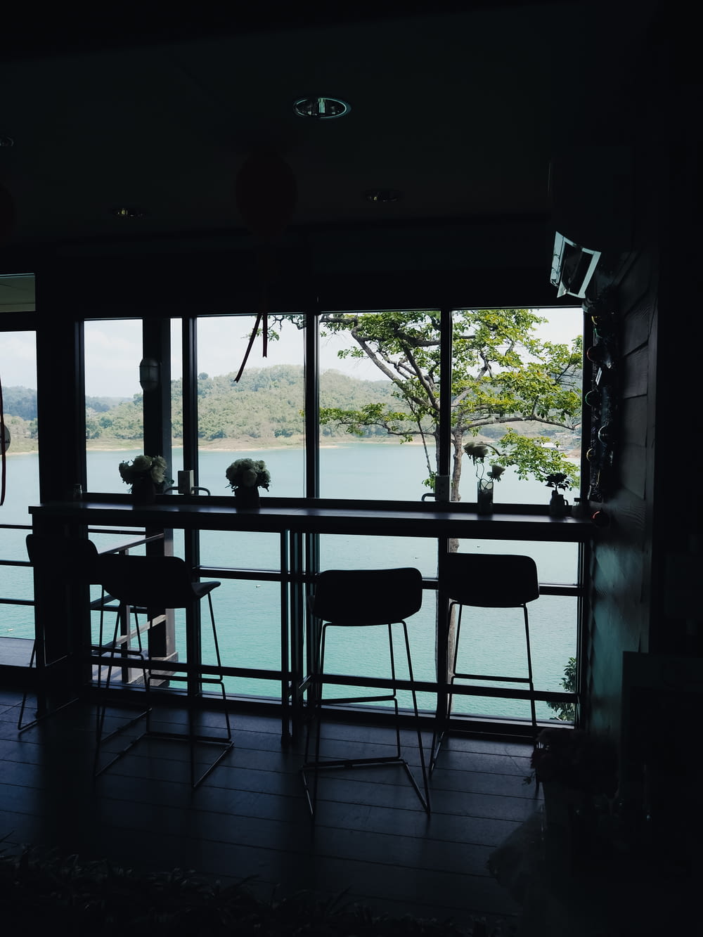 a dining room with a view of a body of water