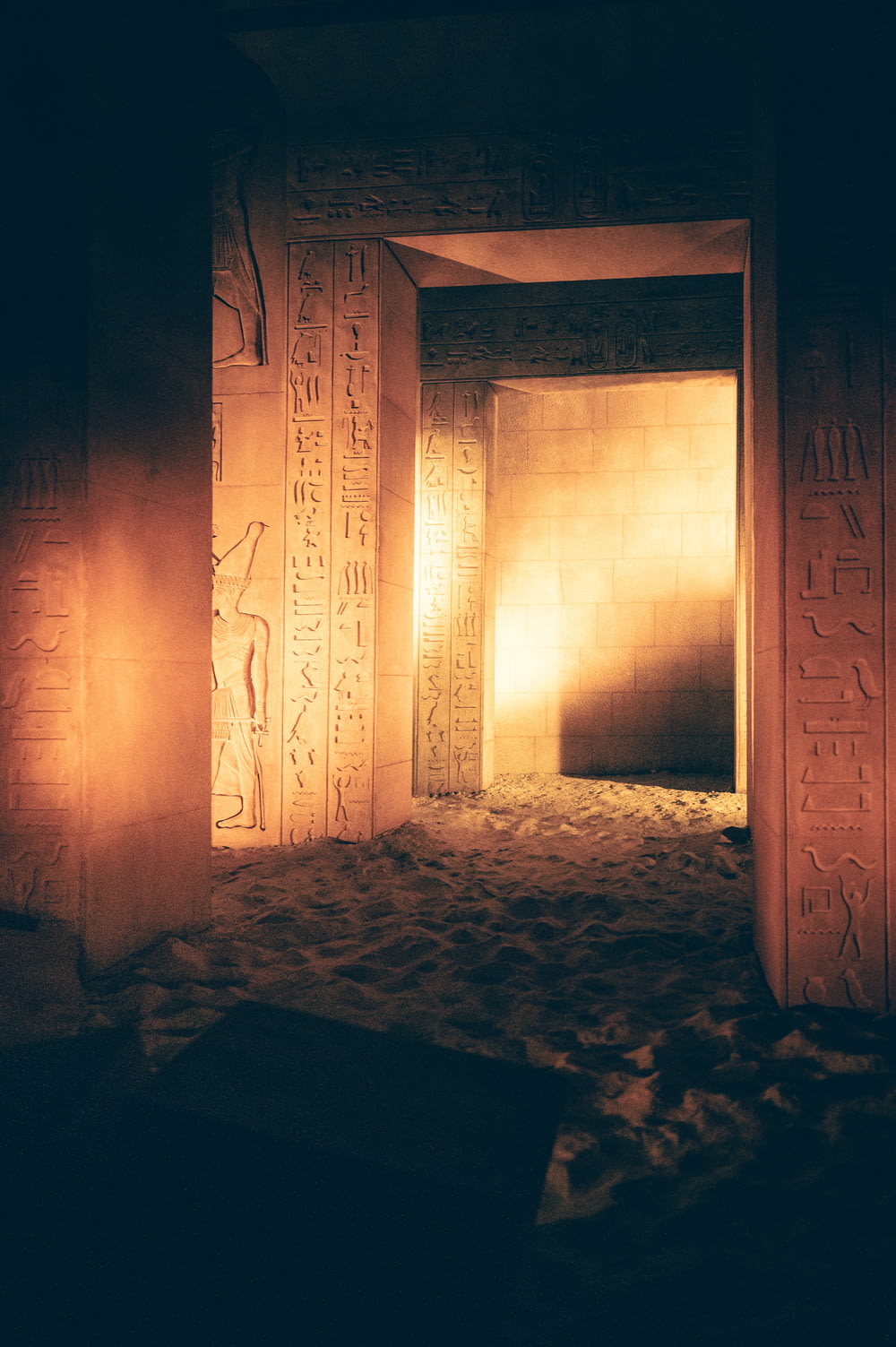 a dimly lit room with egyptian writing on the walls