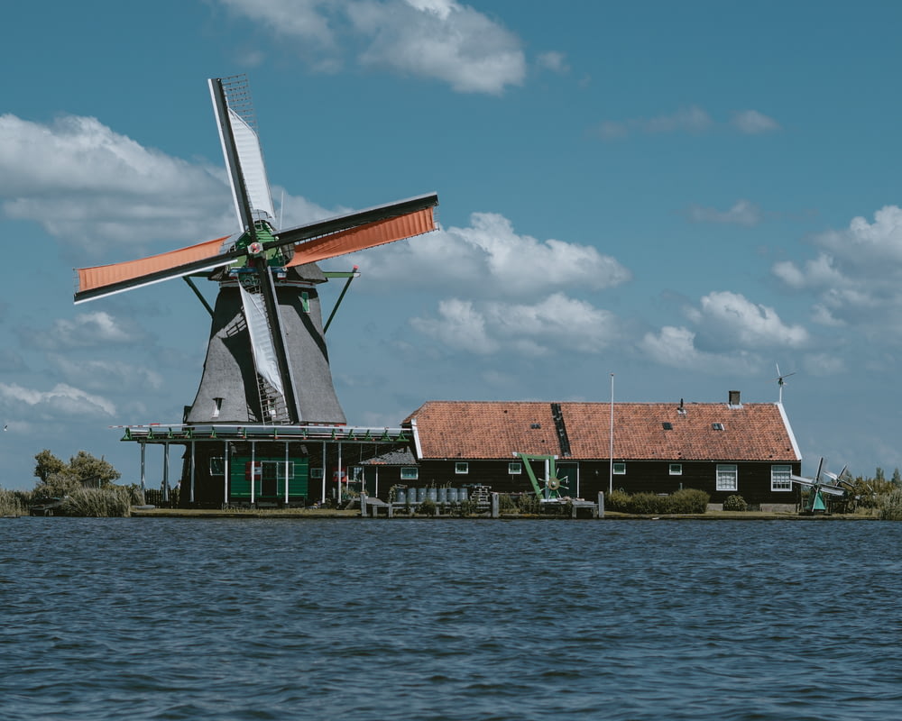 a windmill sitting on top of a body of water