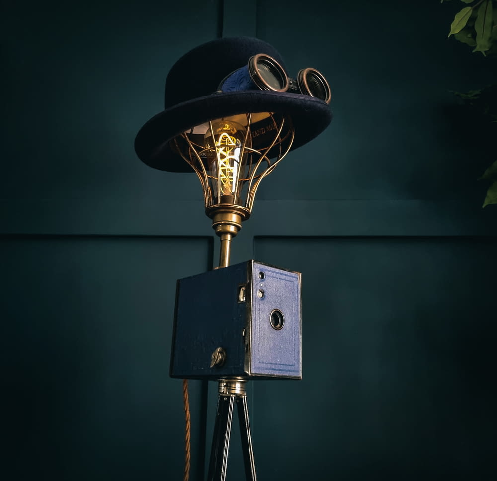 a lamp with a hat on top of it