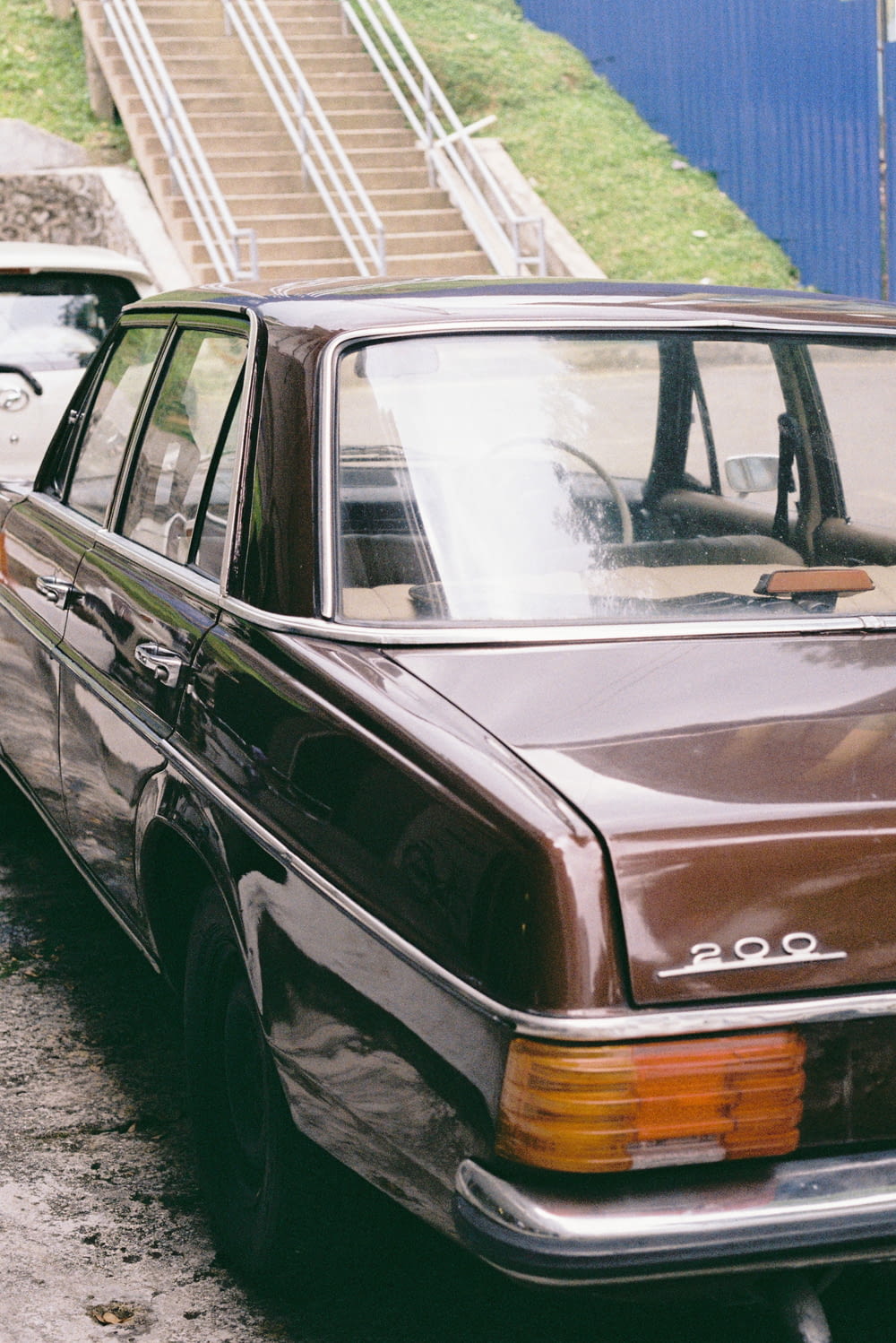 a brown station wagon parked on the side of the road