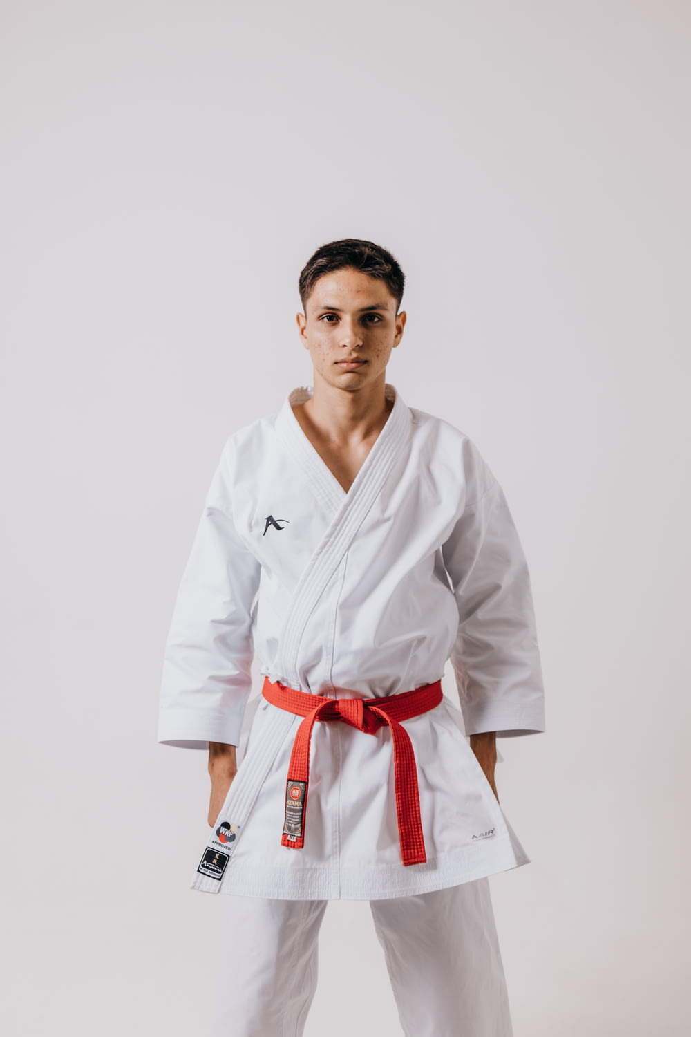 a man in a karate outfit posing for a picture