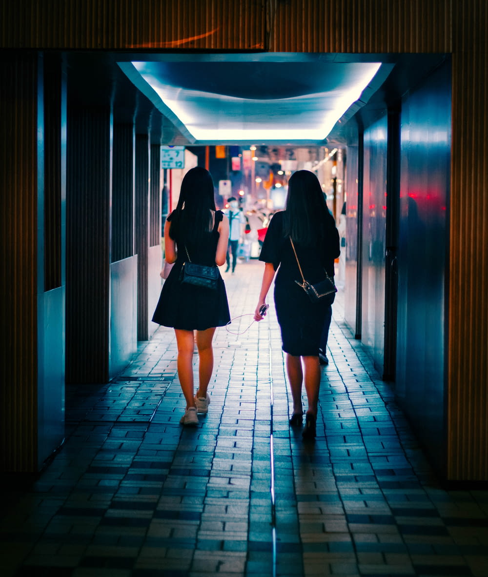a couple of women walking down a hallway