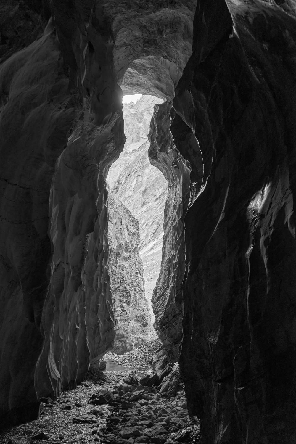 a black and white photo of a narrow tunnel