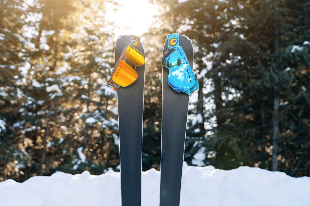 a pair of skis sitting on top of snow covered ground
