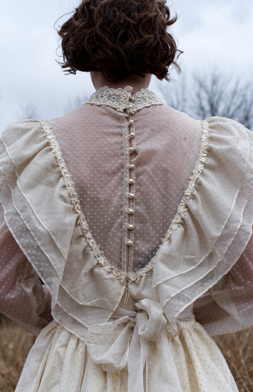 the back of a woman's dress in a field