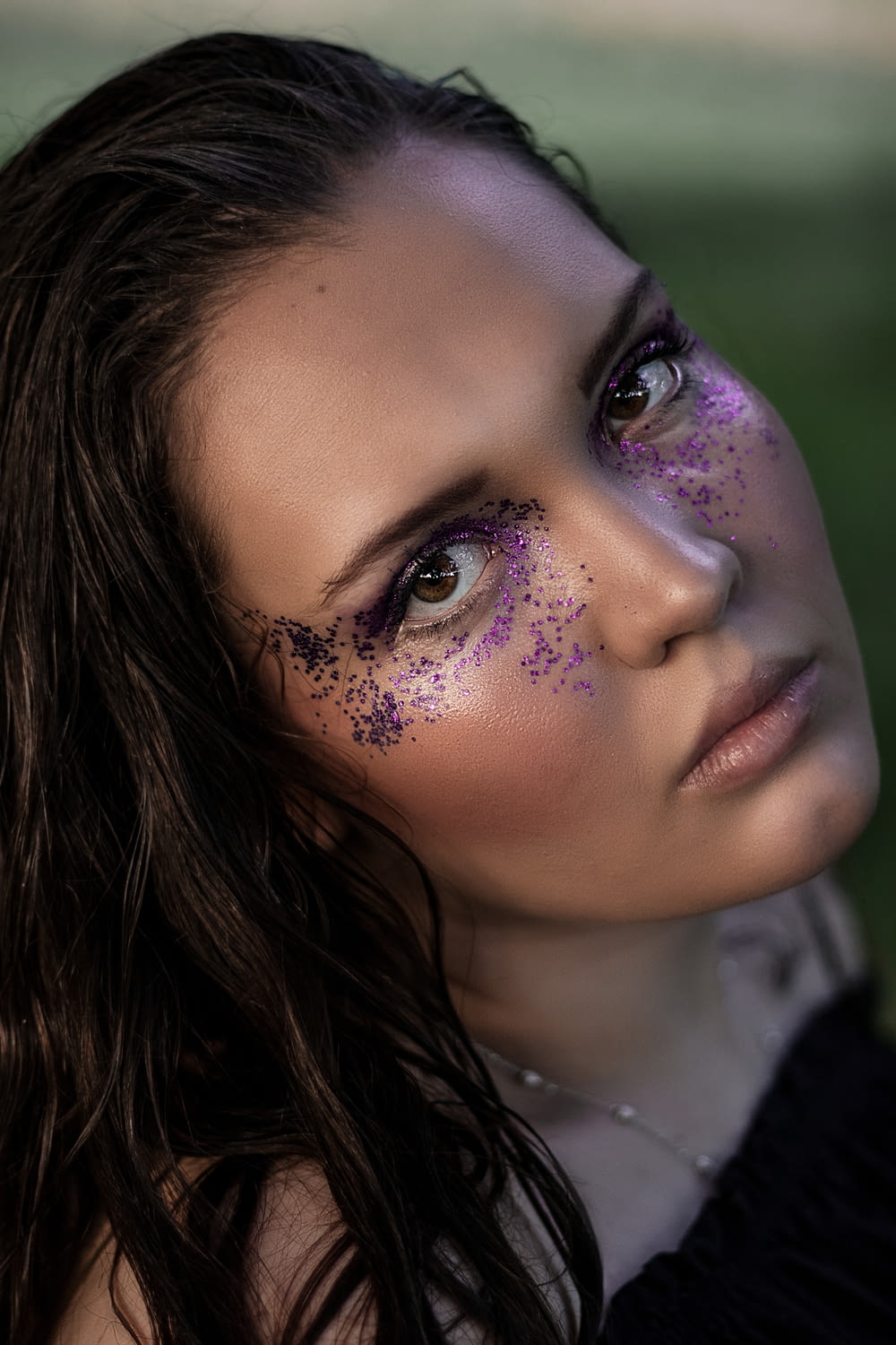 a woman with purple glitter on her face
