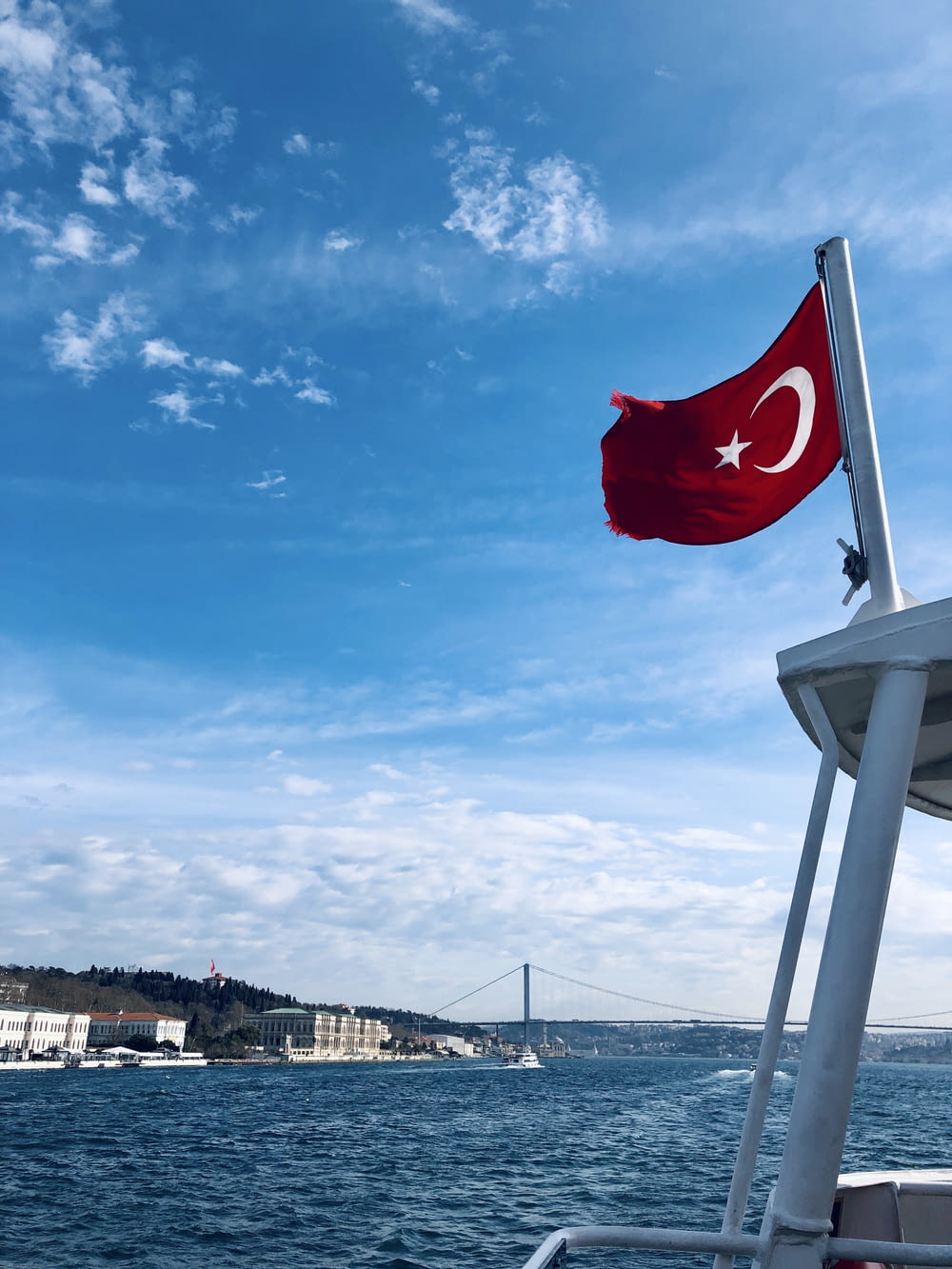 a turkish flag flying on the side of a boat